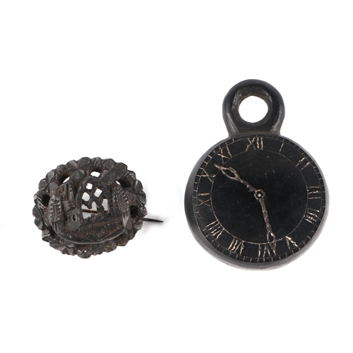 257 - A Victorian Irish bog oak carving in the form of a pocket watch with Roman numerals, 4cms diameter; ... 