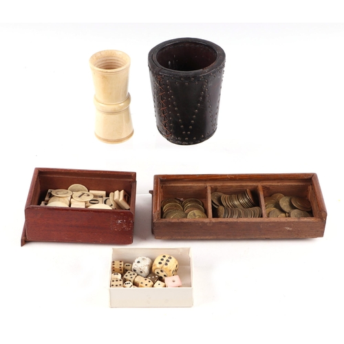 258 - A collection of antique gaming items, including dice, brass gambling tokens, two dice shakers togeth... 