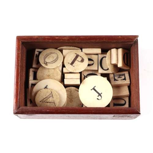 258 - A collection of antique gaming items, including dice, brass gambling tokens, two dice shakers togeth... 