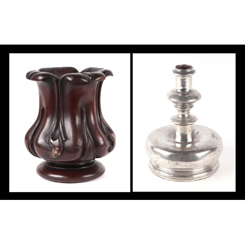 267 - A Victorian carved mahogany vase, 20cms high; together with a squat metal candlestick, 18cms high (2... 