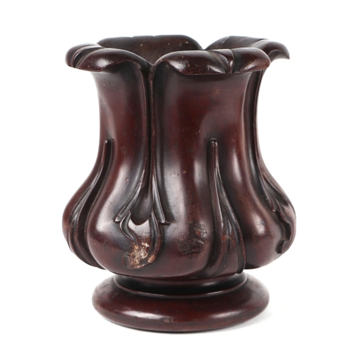 267 - A Victorian carved mahogany vase, 20cms high; together with a squat metal candlestick, 18cms high (2... 