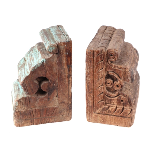 271 - A pair of Indo-Persian carved wood architectural corbels converted into book ends, one having vestig... 