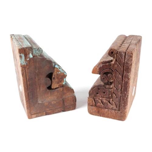 271 - A pair of Indo-Persian carved wood architectural corbels converted into book ends, one having vestig... 