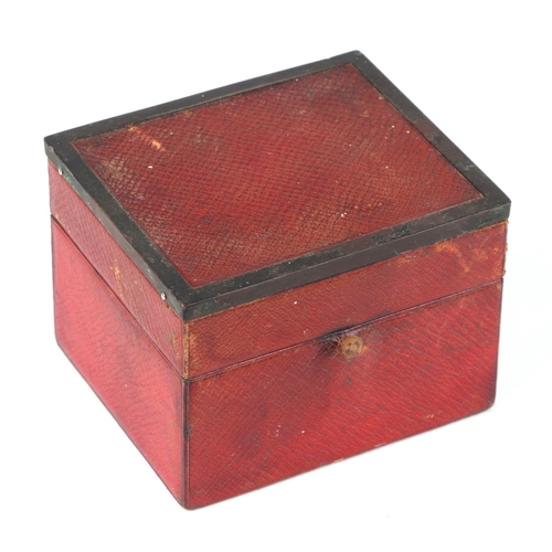 276 - A vintage tooled red leather box containing hardwood whist markers, 12cm wide.