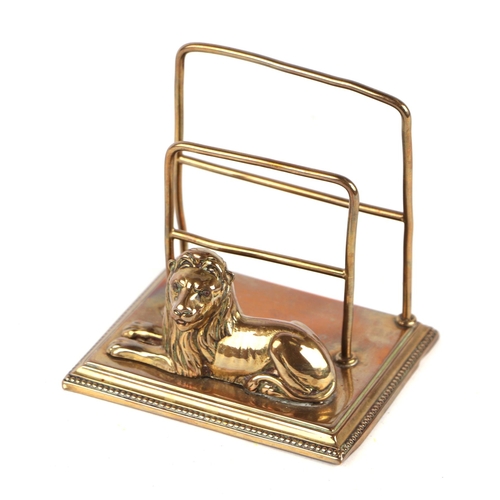 288 - A Regency style two-division letter rack surmounted a recumbent lion, 12cms wide.