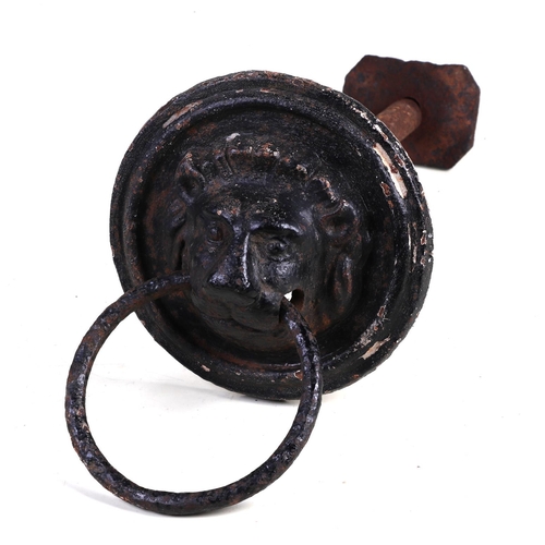 302 - A large 19th century cast iron lion and mask door knocker or horse tether, 15cm diameter