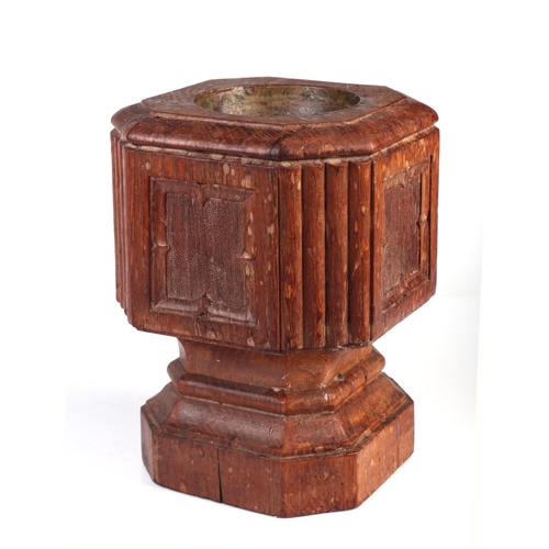 303 - A 19th century carved oak travelling font with brass liner, 23cm high