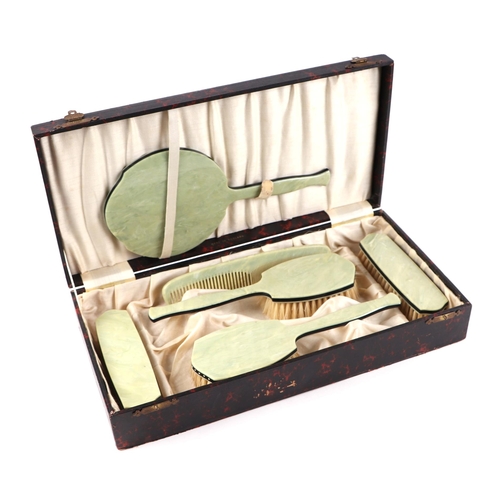 320 - A faux jade bakerlite six pieced dressing table set, in  a faux tortoiseshell case.