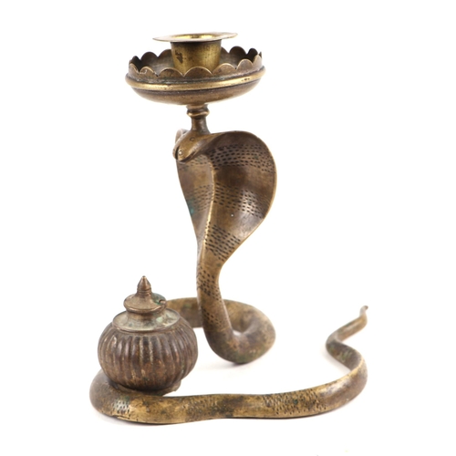 326 - An Indian brass scribes inkwell candlestick in the form of a cobra, 19cms high.