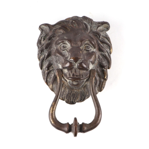 333 - A large cast bronze / brass lion mask door knocker, 21cms high.