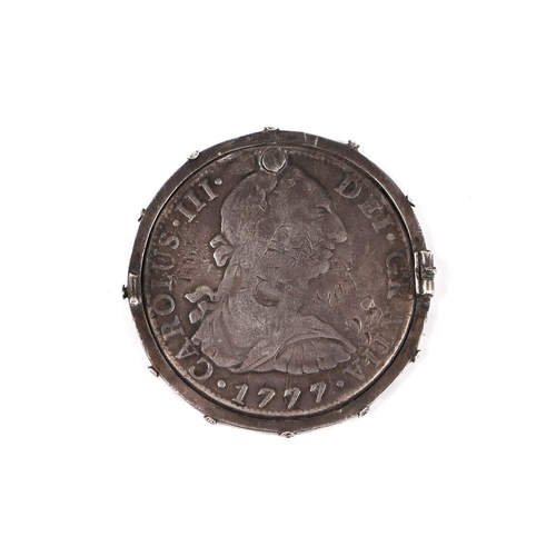 354 - A George III Mexican 1777 8 reals with countermark, in a silver mount.