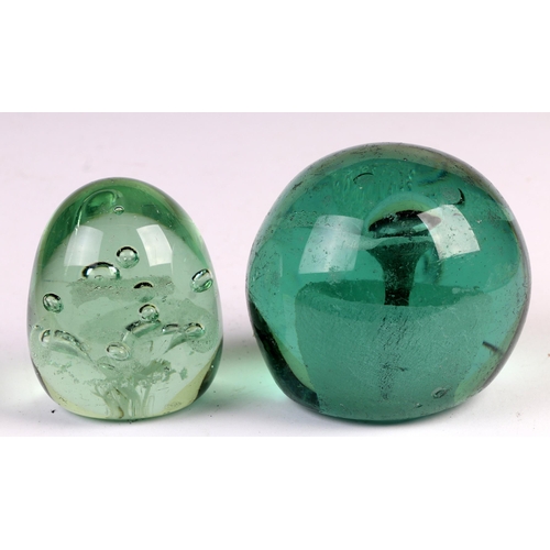 36 - A Victorian glass dump weight, 9cms high; together with another similar, 8cms high, both with floral... 