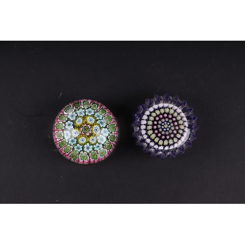 38 - A Baccarat style paperweight with floral canes, 6cms diameter; together with another similar, 6cms d... 