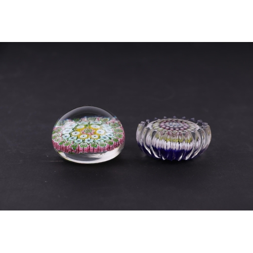 38 - A Baccarat style paperweight with floral canes, 6cms diameter; together with another similar, 6cms d... 