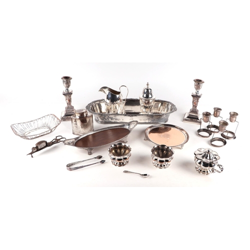 386 - A quantity of silver plated items to include candlesticks, trays, tea caddy and sugar caster.