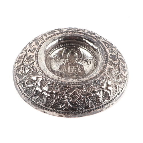 389 - A Ottoman / Greek white metal repousse bowl with central saint figure, 14cms diameter.