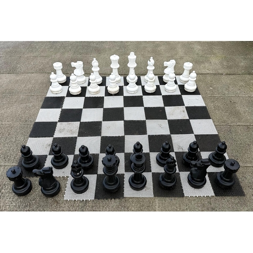 4 - A contemporary plastic oversized garden or public park chess set, king 64cms high.