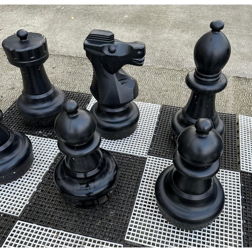 4 - A contemporary plastic oversized garden or public park chess set, king 64cms high.