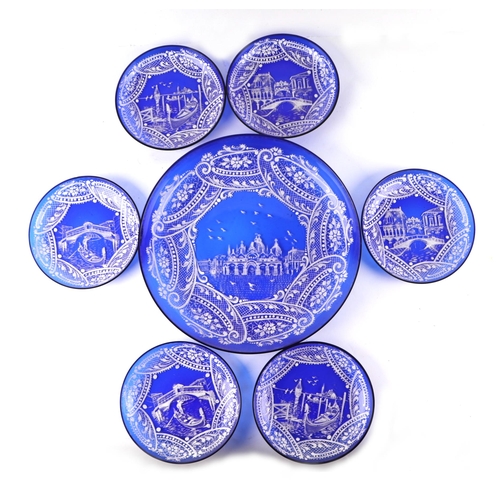 41 - A Venetian blue glass dessert set with white overlay decoration depicting gondolas, the large bowl 2... 