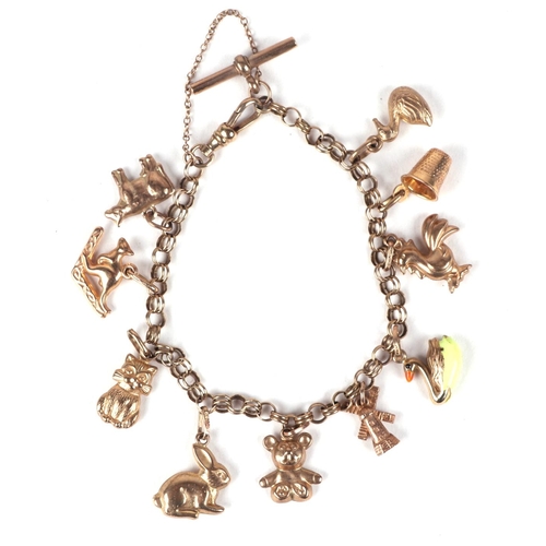 448 - A 9ct gold charm bracelet with various charms to include a cockerel, a rabbit, a teddy bear and a ka... 