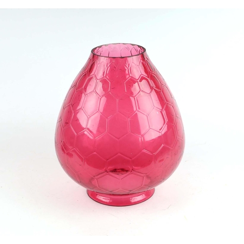 46 - An oversized cranberry glass oil lamp shade with honeycomb design, 31cms high.