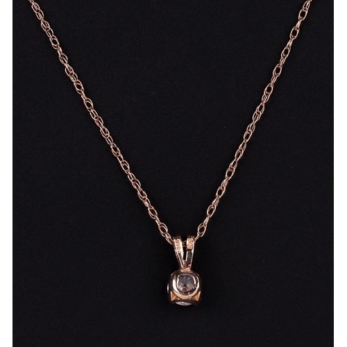 499 - A 15ct gold mounted cubic zirconia pendant on a fine gold chain, 1.4g