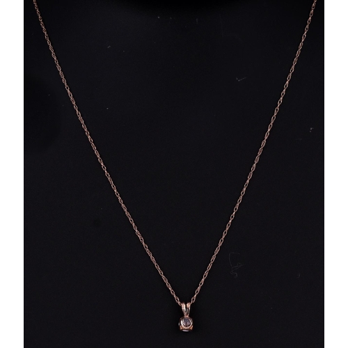 499 - A 15ct gold mounted cubic zirconia pendant on a fine gold chain, 1.4g