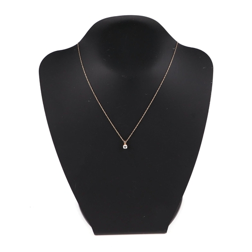 499 - A 15ct gold mounted cubic zirconia pendant on a fine gold chain, 1.4g