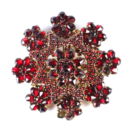 537 - Three Victorian garnet set brooches; together with a four row garnet set bangle.