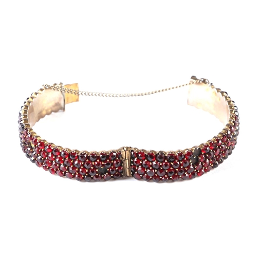 537 - Three Victorian garnet set brooches; together with a four row garnet set bangle.