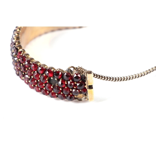 537 - Three Victorian garnet set brooches; together with a four row garnet set bangle.