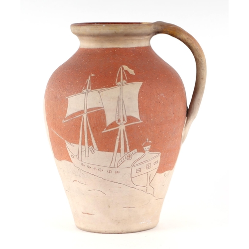 54 - A West Country Art pottery slipware jug decorated with a sailing ship and an Egyptian Faluka boat, i... 