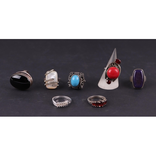 568 - Seven silver gem set rings, to include coral and garnet examples, 51g (7)