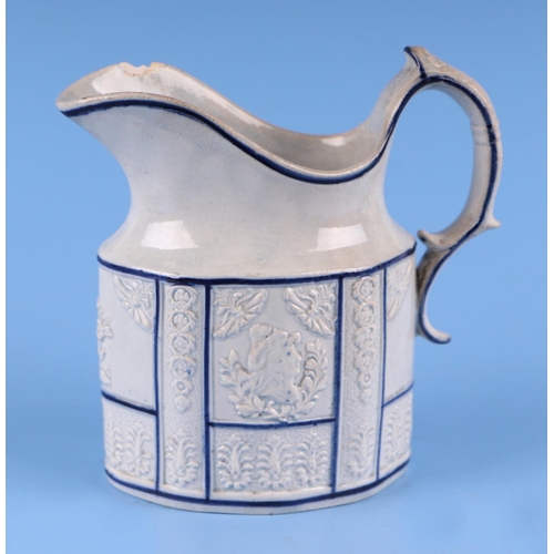 57 - A 19th century English pottery jug decorated in relief with the American Eagle, 12cms high.Condition... 