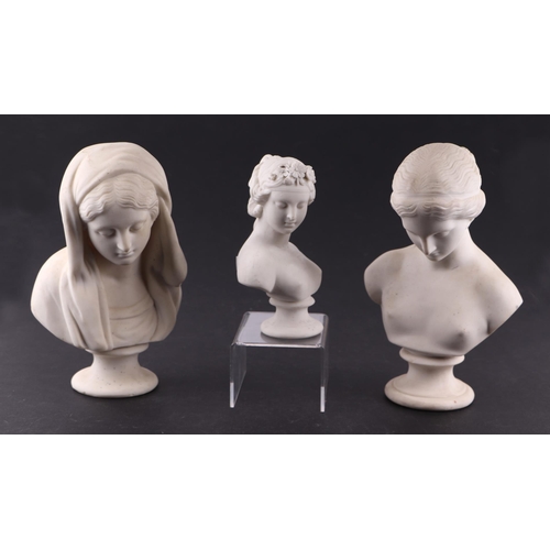 61 - A group of three antique Parian busts depicting classical women, the largest 22cms high (3).