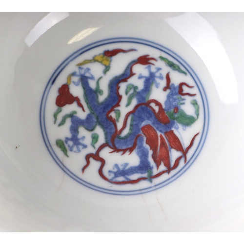 612 - A Chinese Wucai style footed bowl decorated with dragons amongst clouds, six character blue mark to ... 