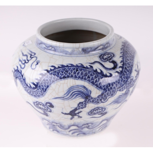 613 - A Chinese blue & white crackleware vase decorated with a dragon amongst clouds, 20cms high.