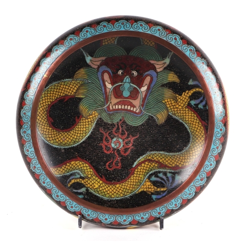 619 - A Chinese cloisonné enamel bowl decorated with a dragon, four character mark to base, 20cms diameter... 