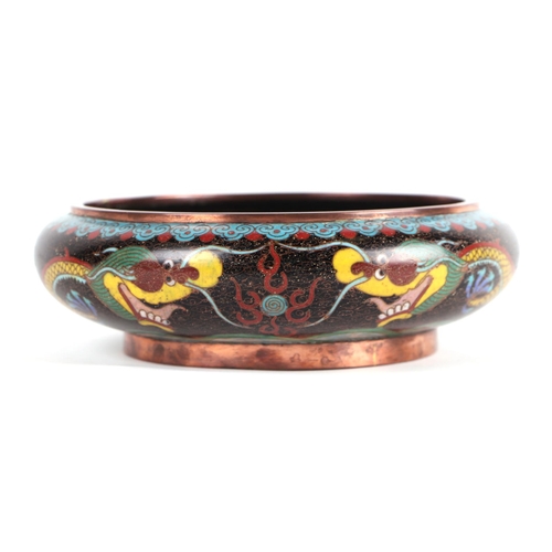 619 - A Chinese cloisonné enamel bowl decorated with a dragon, four character mark to base, 20cms diameter... 