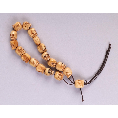 621 - A Tibetan carved bone skull bead necklace.