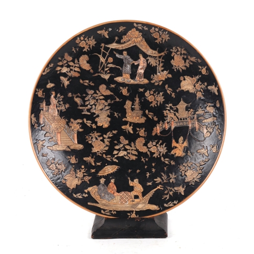 647 - A large Chinese famille noir charger decorated with figures, flowers and butterflies on a black grou... 