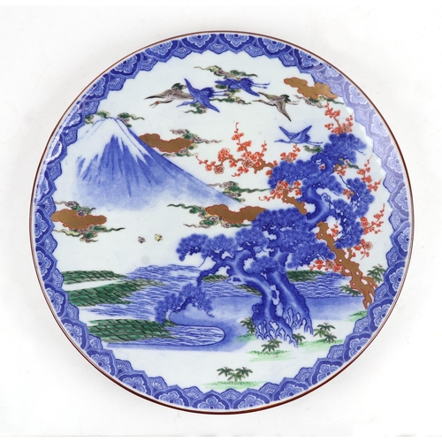 651 - A large Japanese charger decorated with a mountainous landscape scene, 46cms diameter.