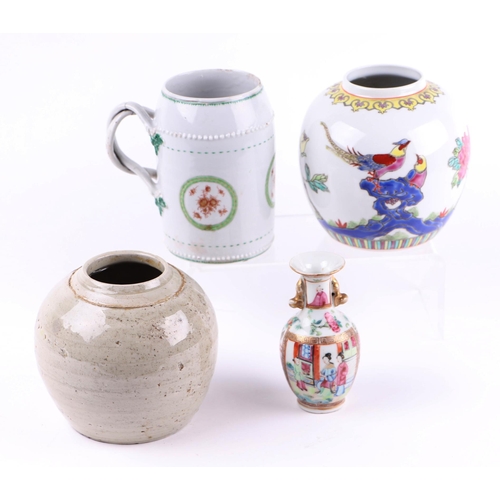 655 - An 18th century Chinese porcelain tankard (a/f), 13cms high; together with a miniature Chinese famil... 