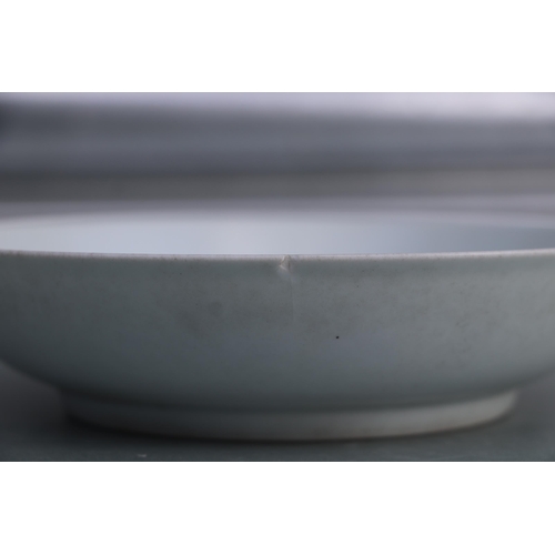 660 - A Chinese white glazed shallow footed bowl, blue six character mark to base, 18cms diameter.Conditio... 