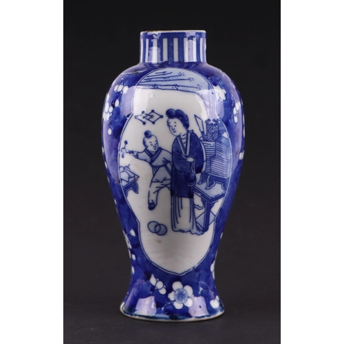 663 - A Chinese blue & white baluster vase decorated with figures within panels, on a cracked ice prunus g... 