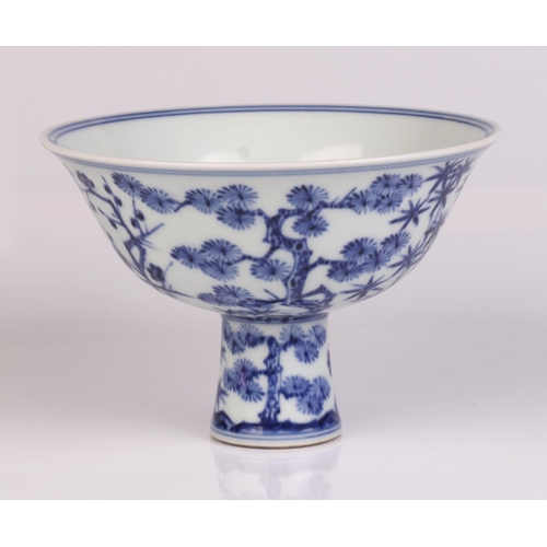 671 - A Chinese blue & white stem bowl decorated with bamboo and fir trees, six character mark to the insi... 