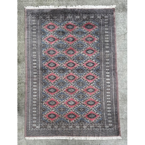 735 - A Caucasian rug, having a multi floral and geometric design on a blue ground, 278cm by 183cm.