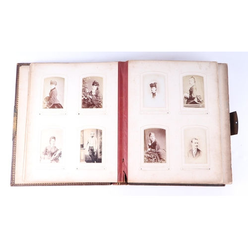 744 - A Victorian tooled leather album of carte de visites and cabinet photographs, the majority portraits... 