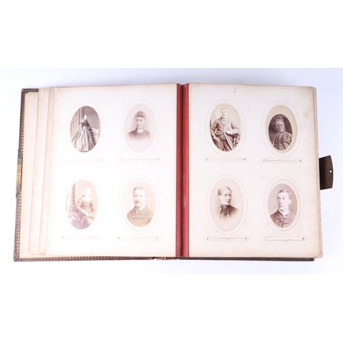 744 - A Victorian tooled leather album of carte de visites and cabinet photographs, the majority portraits... 