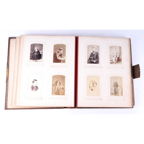 744 - A Victorian tooled leather album of carte de visites and cabinet photographs, the majority portraits... 